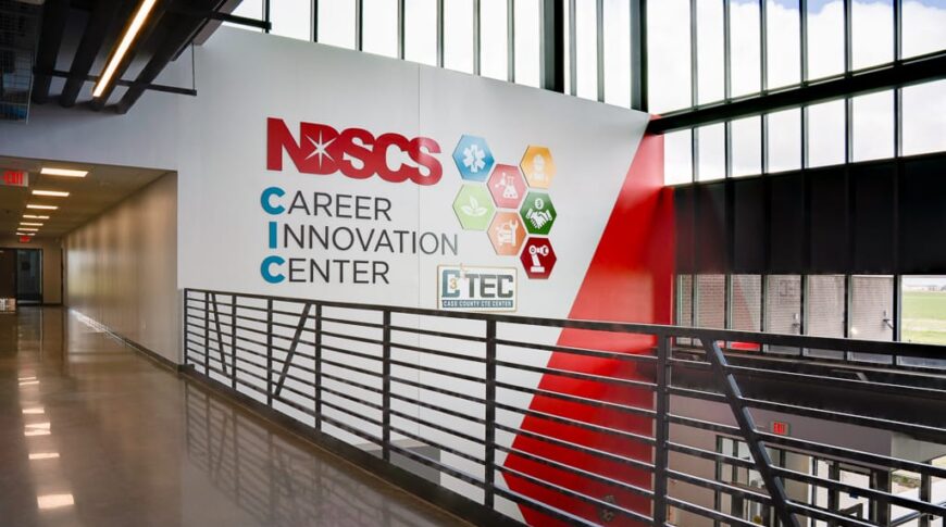 Second story view of the reception area with floor to ceiling windows and a sign that reads "NDSCS Career Innovation Center."