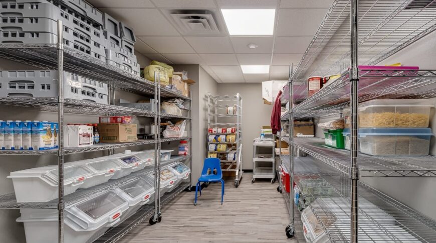 Large pantry with right and left walls of storage walls filled with food.