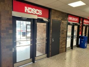 Before image of the NDSCS Blikre Activities Center Entrance Doors from the inside of the building.