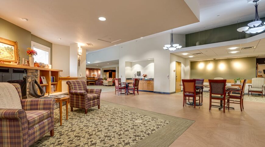PioneerCare-Low Res-52 Redone dining room flooring at PioneerCare Center in Fergus Falls, flanked by fireplace seating area to the right.
