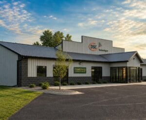 Corner view of Comstock Construction Aberdeen office building with summer blue skies and green grass and trees.