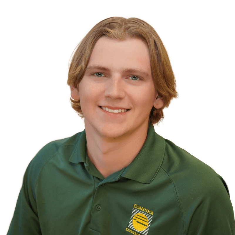 Young man with light skin, blue eyes, and blonde hair wearing green Comstock Construction polo on white background.