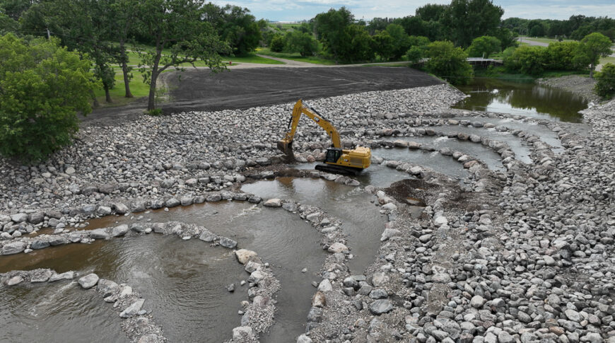 default Excavator placing rocks in Goose River for rock riffle design from deconstructed dam.