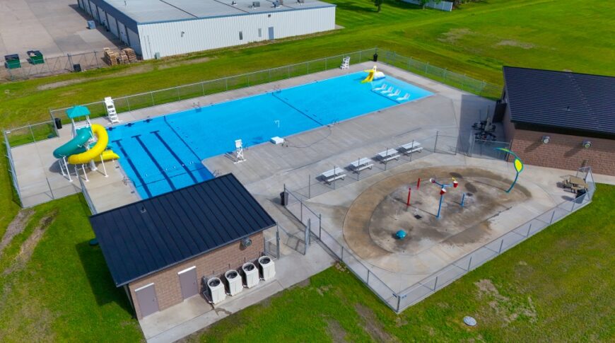 image (4)-small Aerial view of the new Gwinner Aquatic Center with concessions and bathhouse to the right, splash pad besides, mechanic building to the bottom and pool to the top.