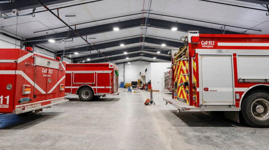 Bottineau Fire Hall - Low Res (7) Interior of newly-constructed prefabricated metal building with concrete floors and fire trucks inside.