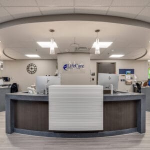 Newly-built nurses station at LifeCare Roseau Manor with a "LifeCare Roseau Manor" sign behind.