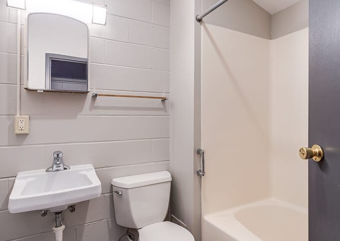 Freshly painted white walls of bathroom with new lvp flooring.