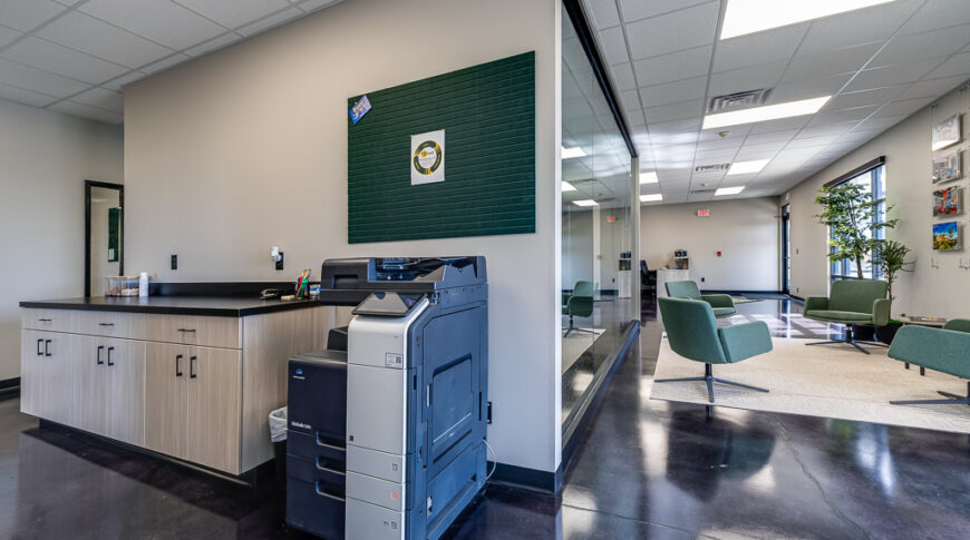 Comstock Construction Aberdeen-Low Res-59 Business station with printer and cabinetry besides, overlook an office reception area.