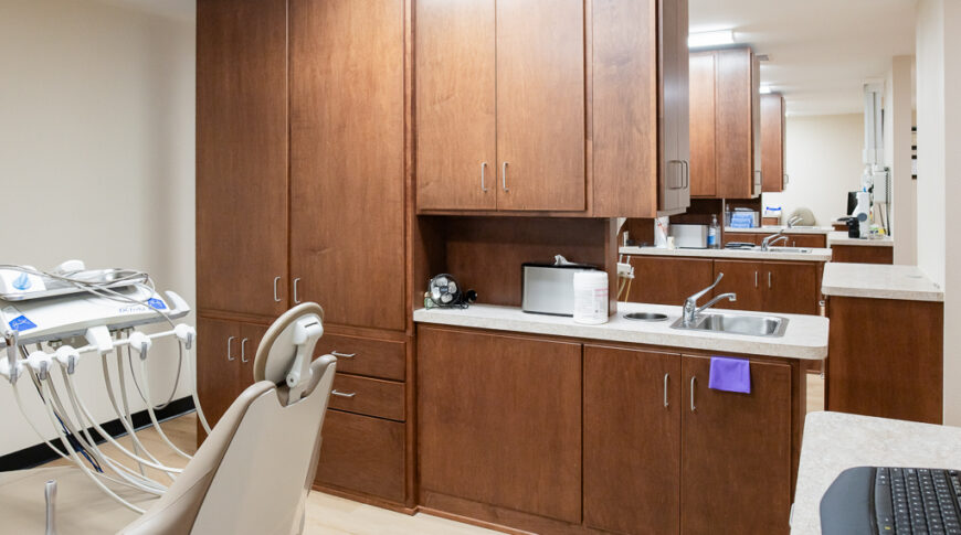 Aberdeen Dental in Britton-Low Res-18 View down the dental office showing four dental stations with wooden cabinetry as privacy dividers.