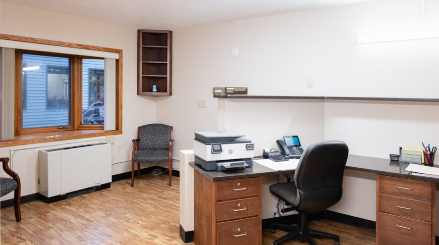 Aberdeen Dental in Britton-Low Res-41 Reception office at Aberdeen Dental in Britton, SD with desk and swivel chair in the middle and window to the back left wall.