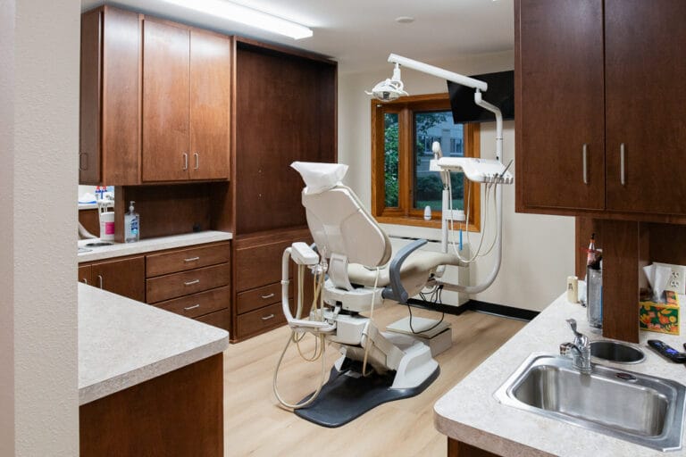 Aberdeen Dental in Britton-Low Res-5 Dental station with brown wood cabinetry surrounding a dental chair.