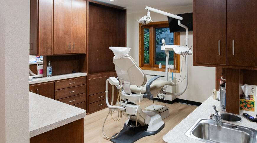 Aberdeen Dental in Britton-Low Res-5 Dental station with brown wood cabinetry surrounding a dental chair.
