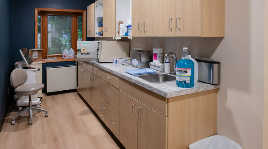 Aberdeen Dental in Britton-Low Res-9 Galley station with light wood cabinetry on one side, window to the back wall.